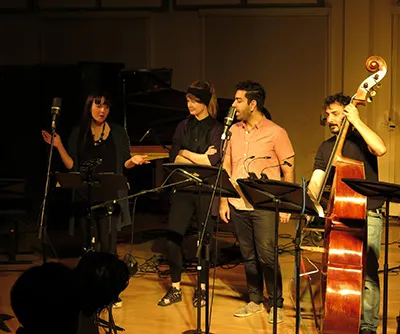 Ferhat Öz singing with a vocal ensemble