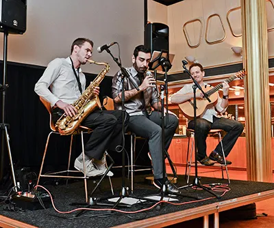 Ferhat Öz performing with saxophone and guitar
